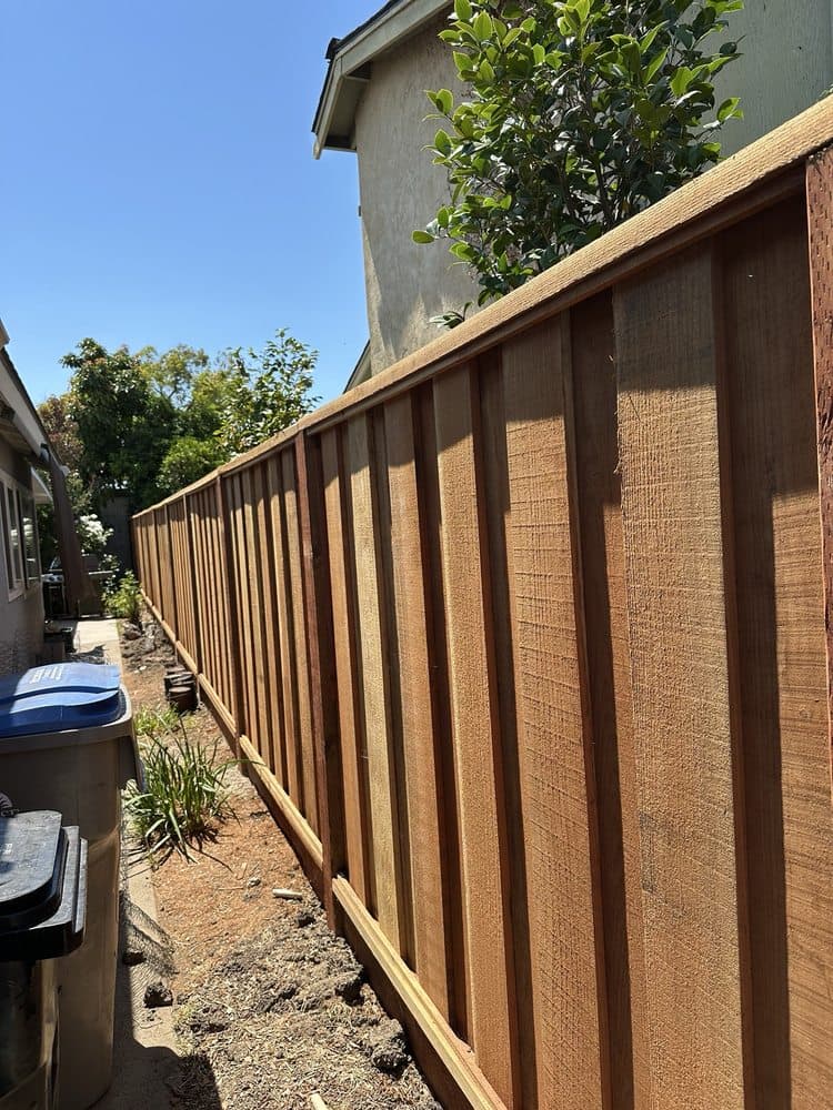 New redwood board fence with a clean top cap running the length of a Bay Area side yard