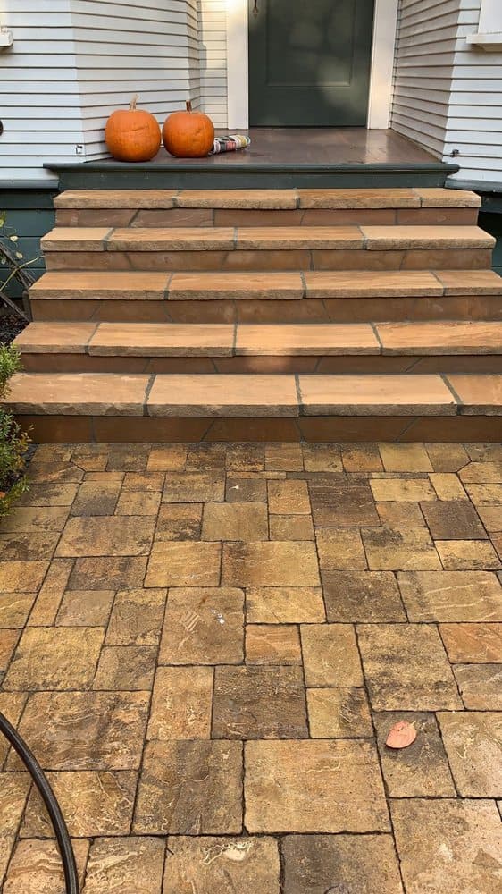 Natural stone paver steps and landing leading to the entry of a refined Hillsborough home