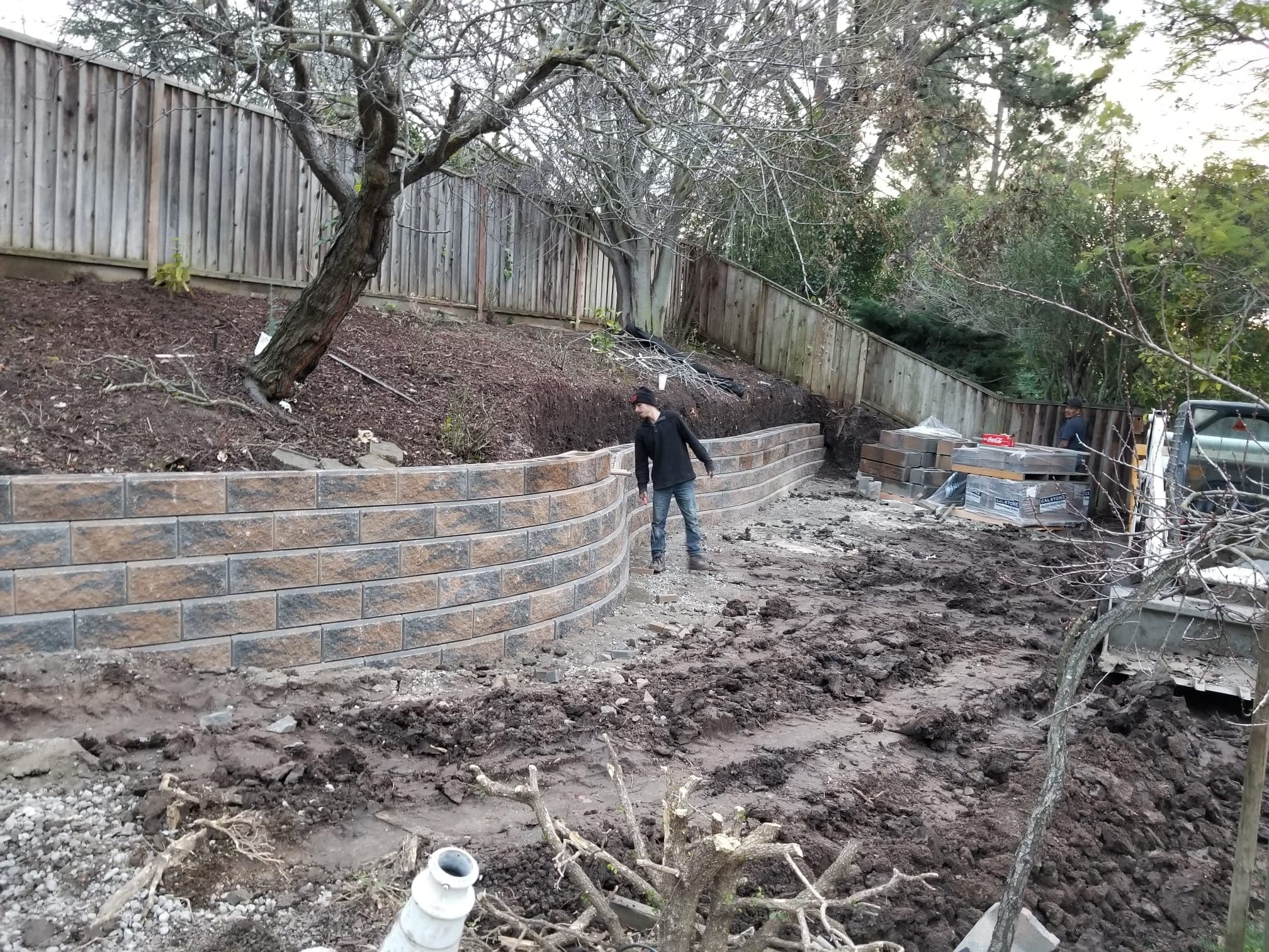 Bedolla’s dedicated crew member carefully building a stone wall with craftsman pride on a Bay Area property